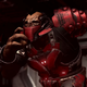 Craig the Brute runs down a hallway toward Master Chief in Halo Infinite.
